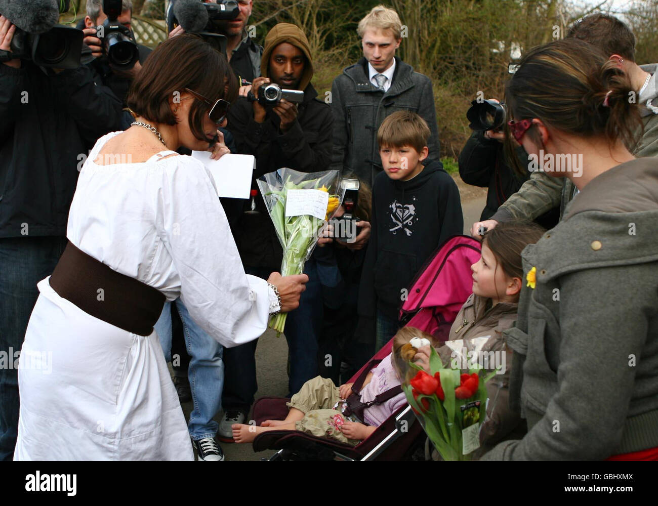 Jackiey Budden, the mother of Jade Goody, receives flowers from six year old Kiara Gascoigne (second right), 6, and her mother Jenny (right), 30, from Woodford Halse in Northamptonshire, following Jade's death in the early hours of this morning at her home in Upshire, Essex. Stock Photo