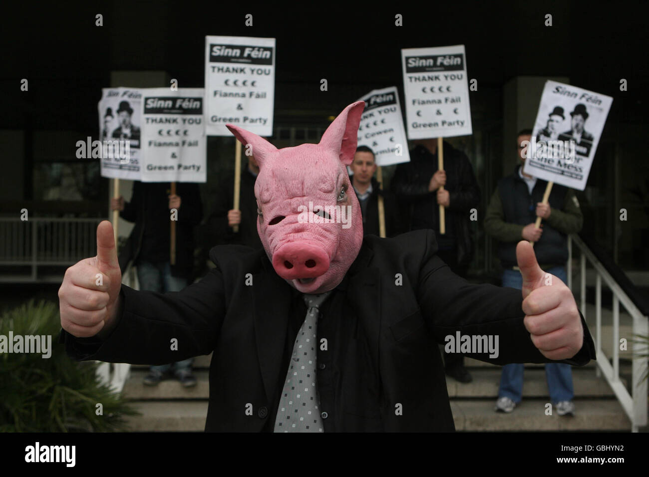 A Sinn Fein activist dressed as a pig carrying bags of money outside the  Irish Nationwide Building society in Dublin today as the government meets  to discuss one million euro bonus paid
