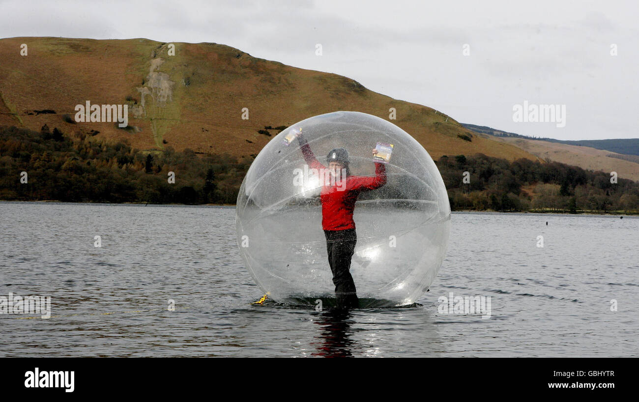 Tara Vallente, inside the inflatable ball on Derwent Water, Keswick, that enables you to walk on water, which is the latest adventure on offer during the Keswick Mountain Festival. Stock Photo