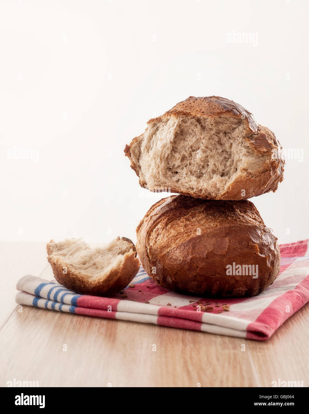 Rustic crusty bread on a red towl on a table Stock Photo