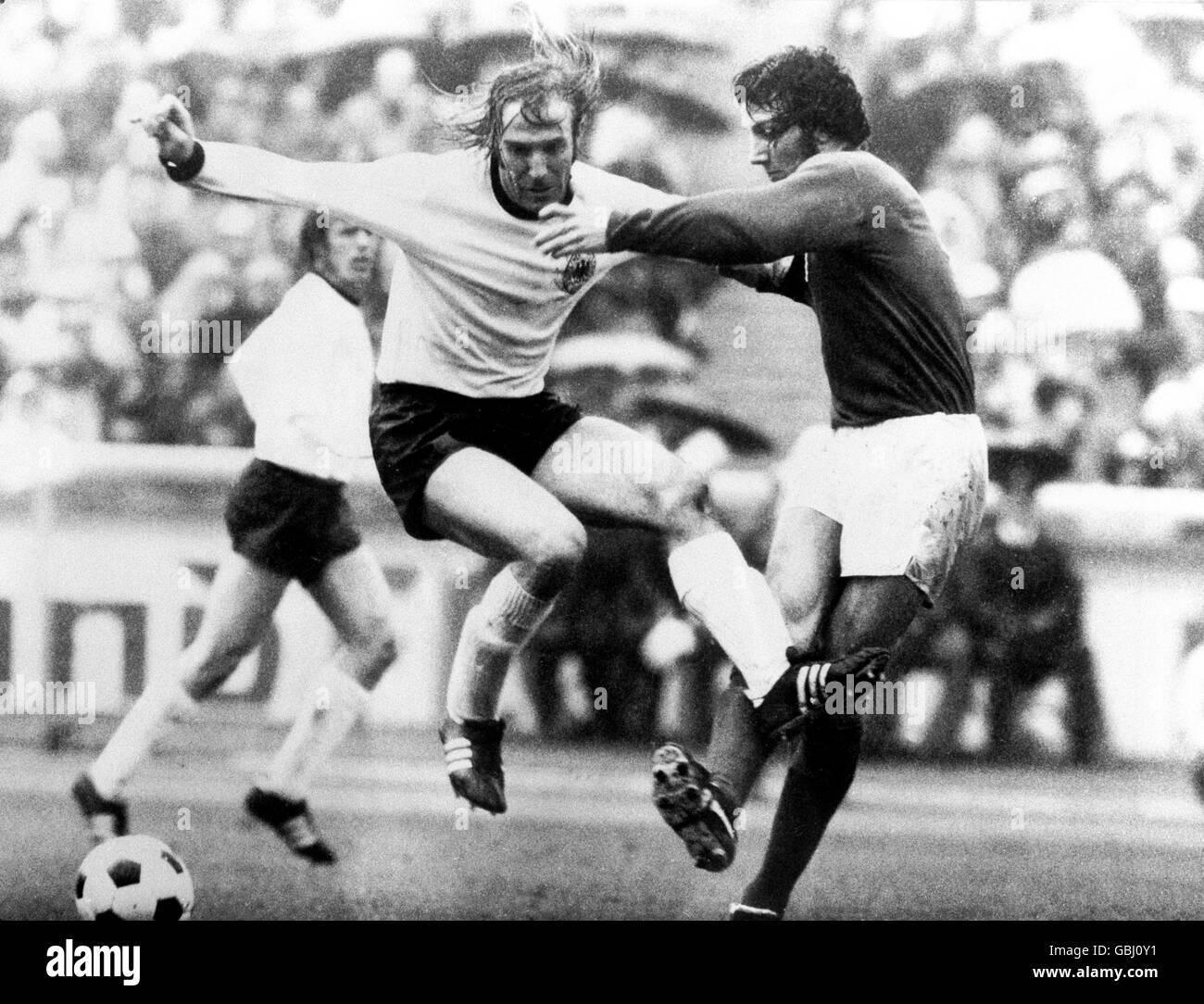Soccer - European Championships - Quarter Final Second Leg - West Germany v England. England's Roy McFarland (r) tackles West Germany's Gunter Netzer (l) Stock Photo