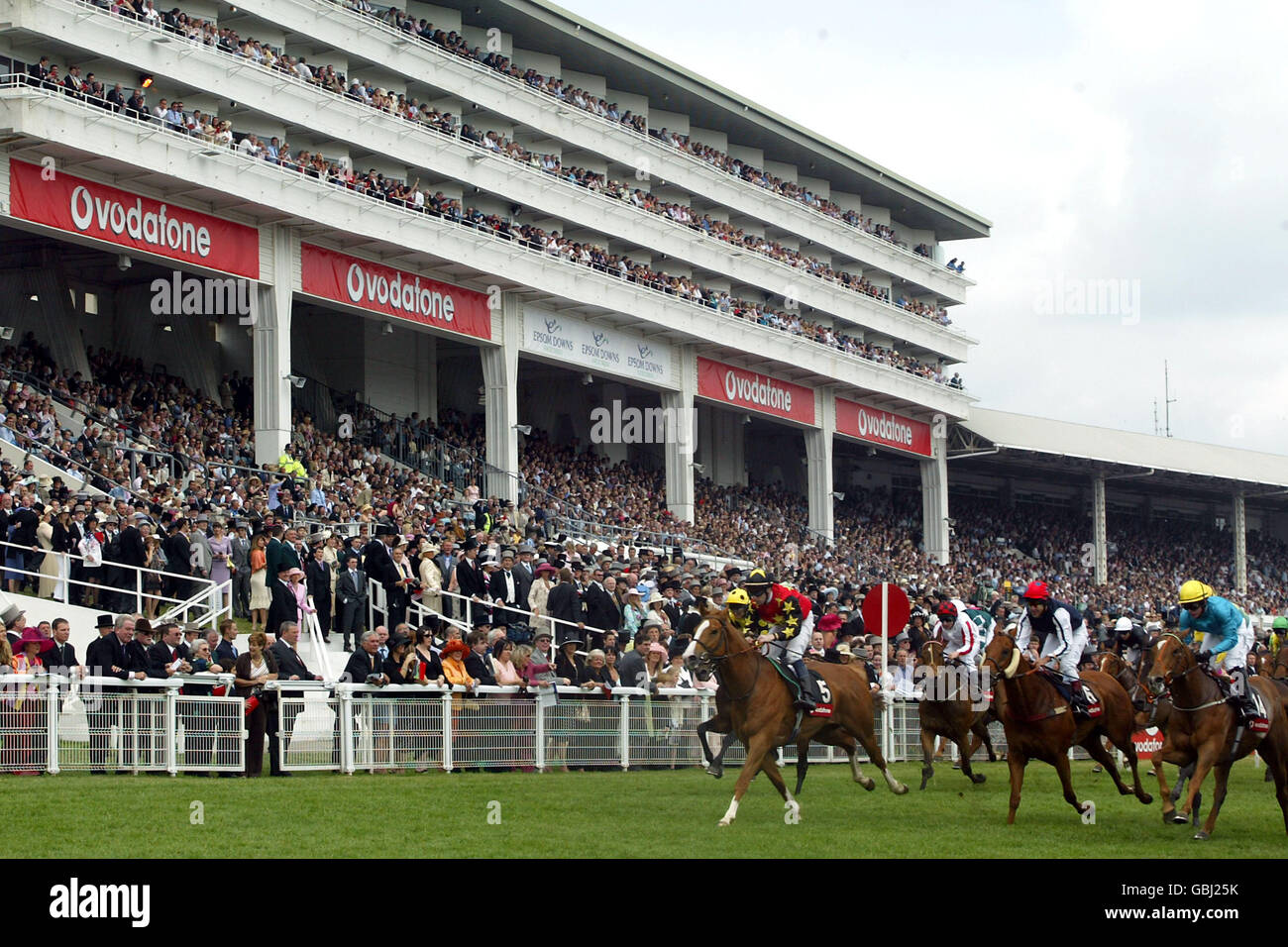 Horses running past the epsom grandstand hires stock photography and