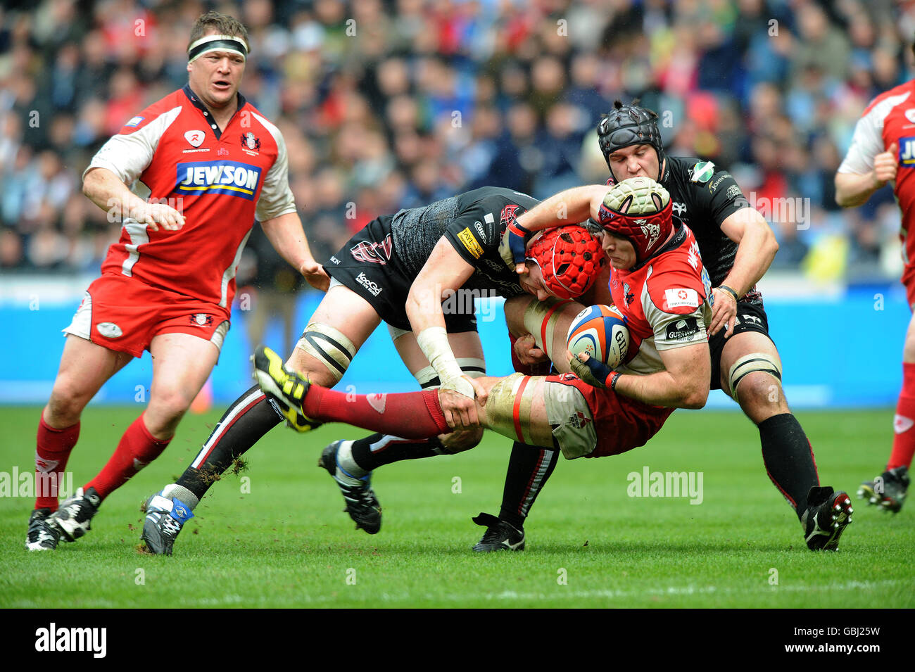 Gloucester rugbys alasdair strokosch tackled by ospreys ryan jones hi