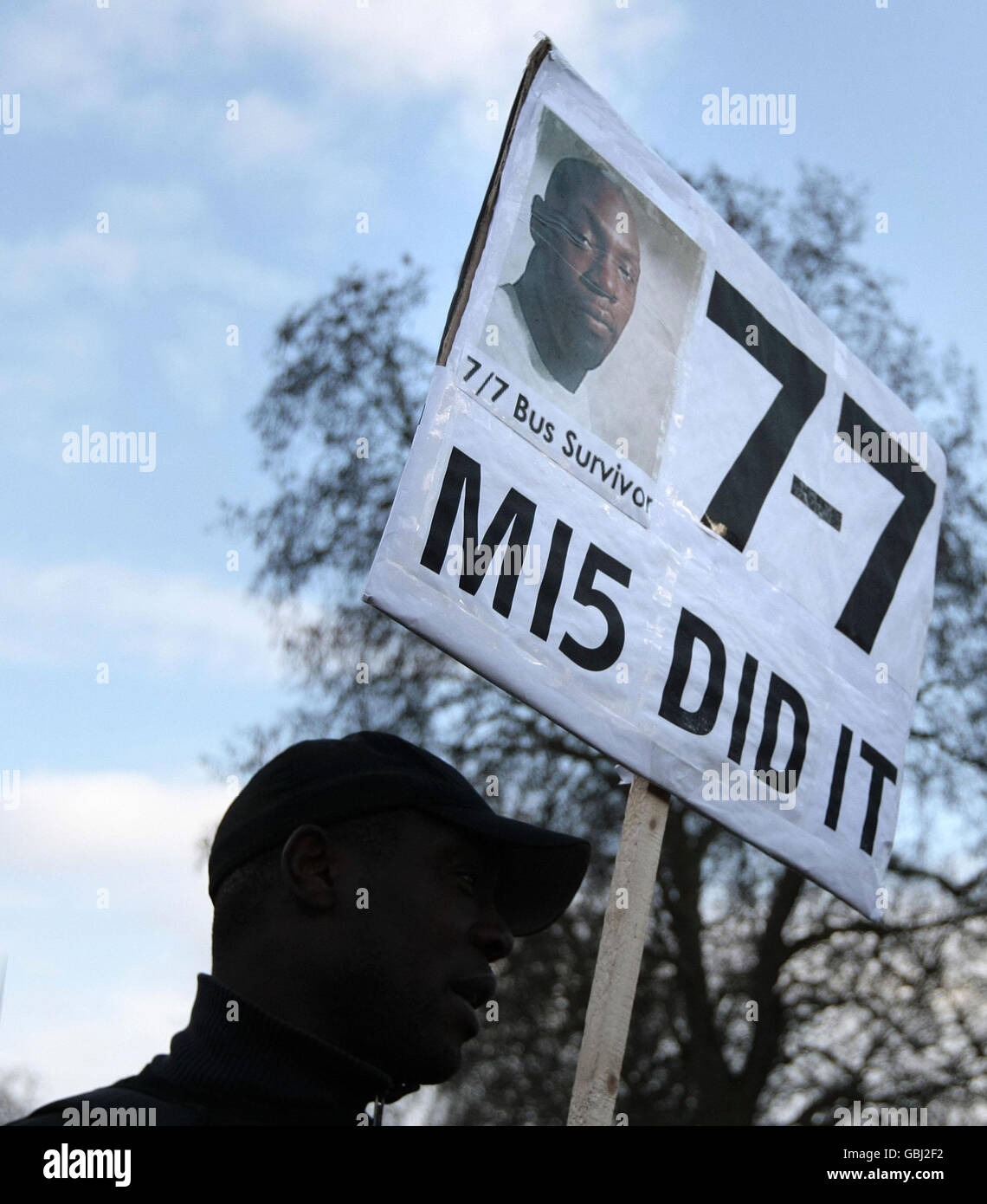 A man at Speakers Corner, Hyde Park, London, holds a placard alleging