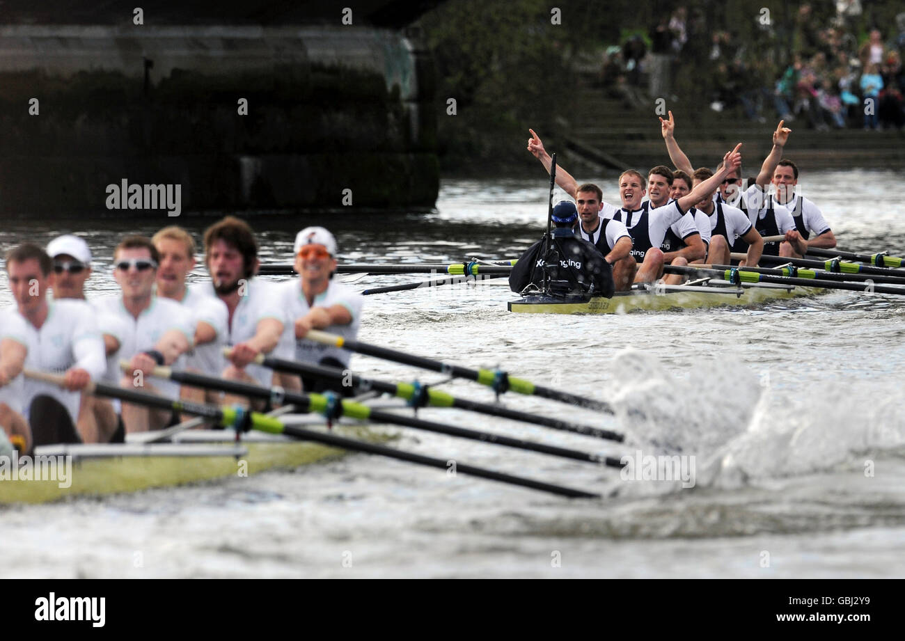The Oxford crew (right) celebrate their victory as the Cambridge team row to the finish in