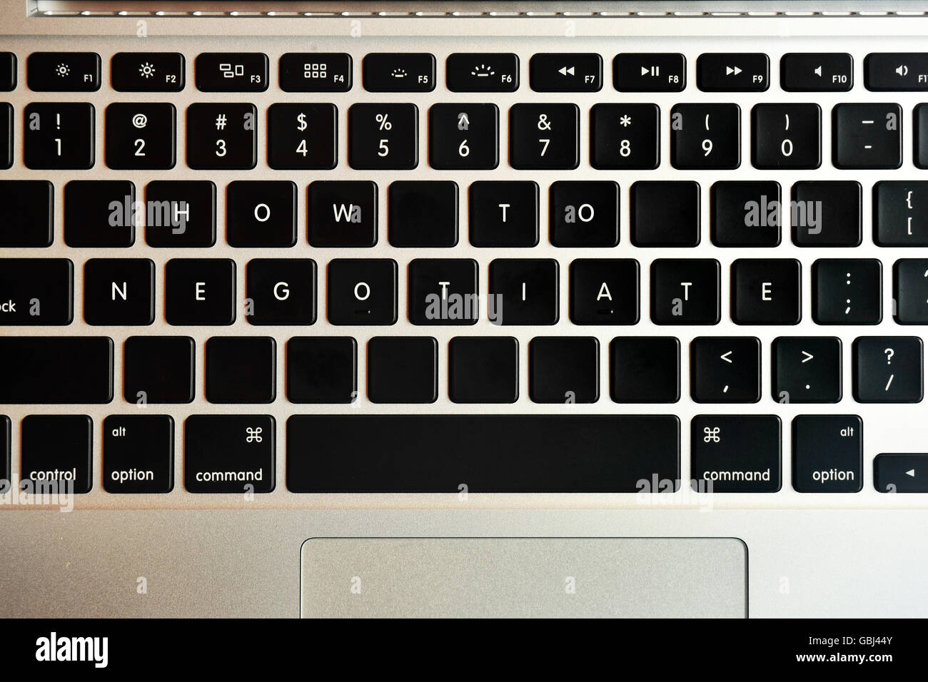 How to negotiate written on the keys of a Mac keyboard. Stock Photo