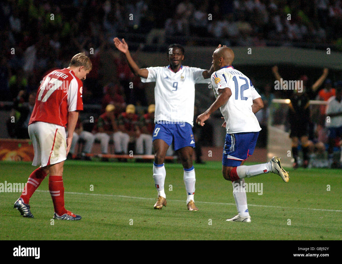 Soccer - UEFA European Championship 2004 - Group B - Switzerland v France. France's Thierry Henry celebrates scoring the third goal with teammate Louis Saha Stock Photo