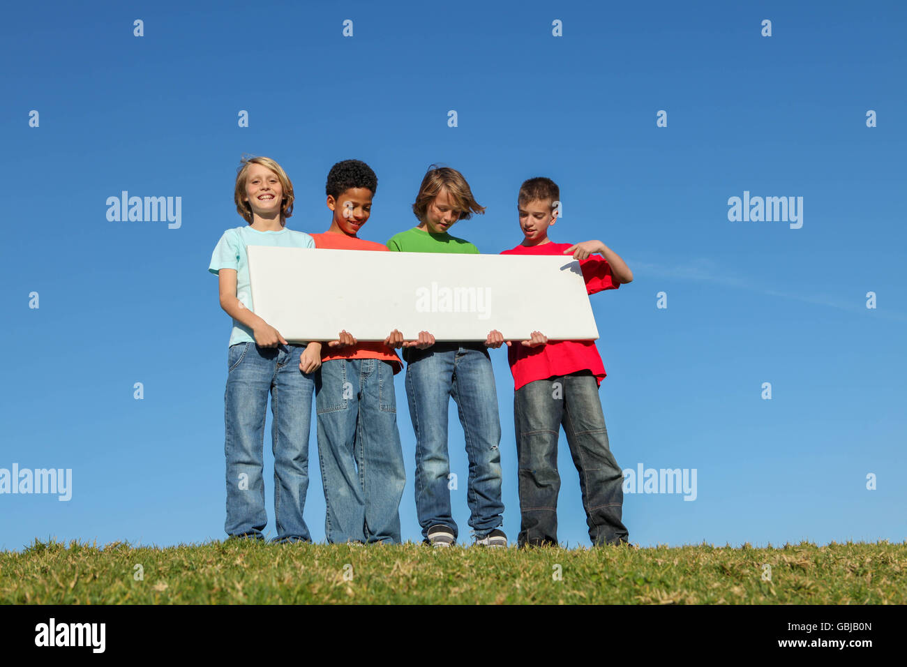 diverse kids holding blank sign Stock Photo - Alamy