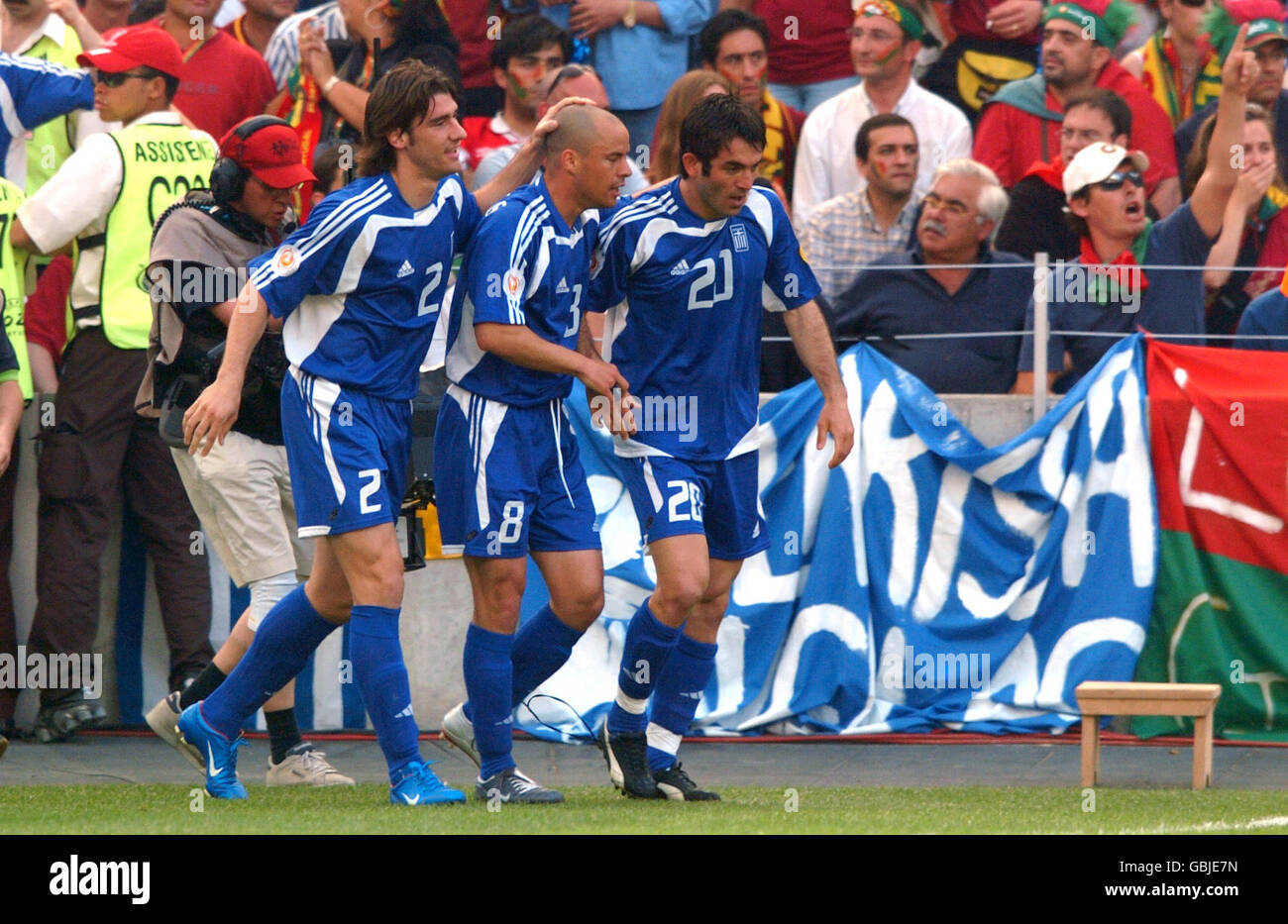 Greece's Georgios Karagounis celebrates scoring the opening goal with teammates Georgios Seitaridis (l) and Stylianos Giannakopoulos (c) Stock Photo