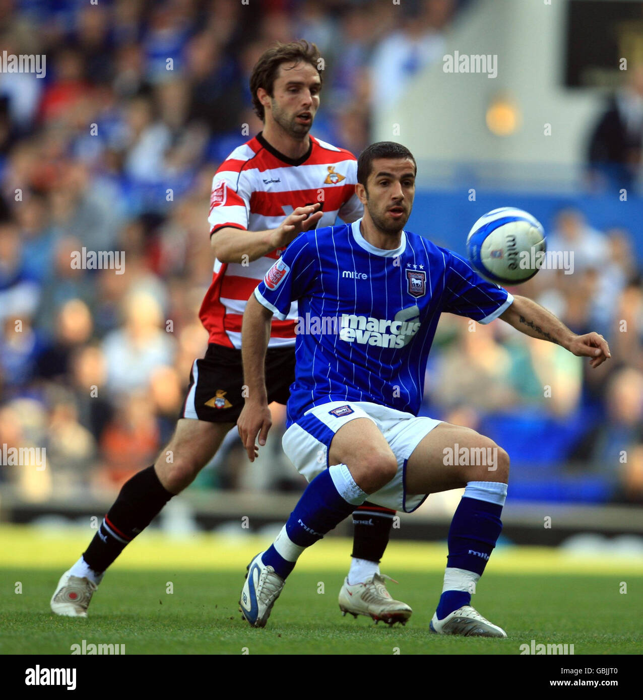 Ipswich Town's Pablo Counago (front) and Doncaster Rovers' Mark Wilson (back) battle for the ball during the Coca-Cola Football League Championship match at Portman Road, Ipswich. Stock Photo