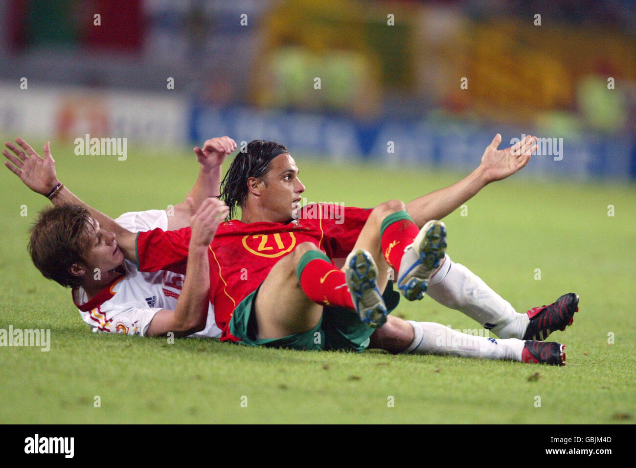 Soccer - UEFA European Championship 2004 - Group A - Spain v Portugal. Portugal's Nuno Gomes appeals for a free kick after being pulled to the floor by Spain's Xabi Alonso Stock Photo