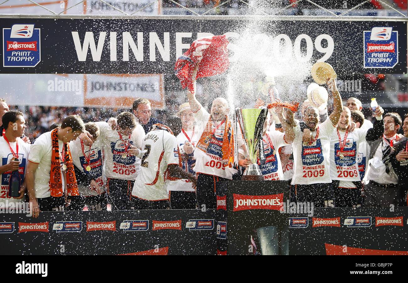 Luton town players celebrate after winning the johnstones paint trophy