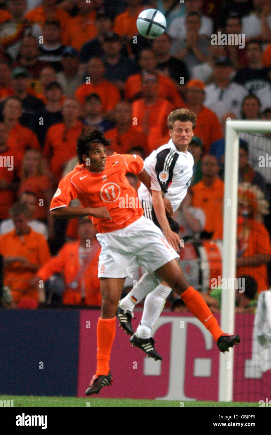 Germany's Christian Worns (r) and Holland's Pierre Van Hooijdonk jump for the ball Stock Photo