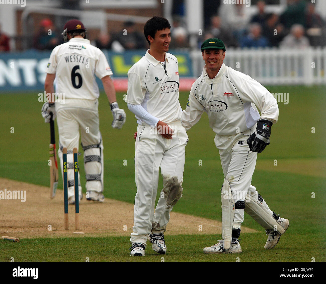 Leicestershire's wicketkeeper Paul Nixon (left) congratulates Sam Cliff (centre) after bowling Northamptonshire's Riki Wessels during the County Championship Division One match at Grace Road, Leicester. Stock Photo