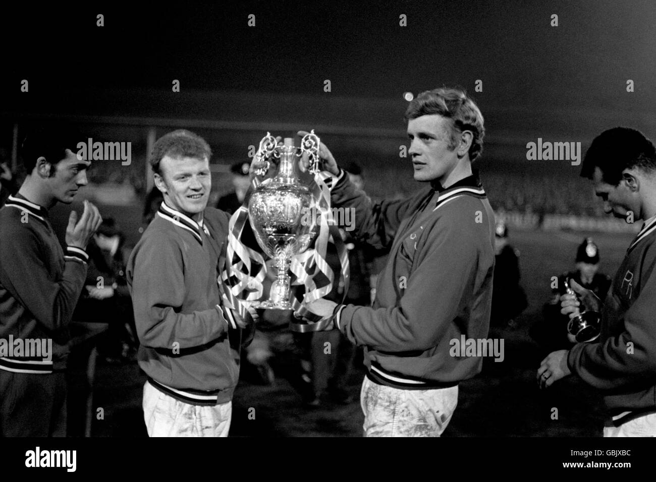 Leeds United's Billy Bremner (l) and Gary Sprake (r) show off the League Championship trophy to the fans at Elland Road Stock Photo