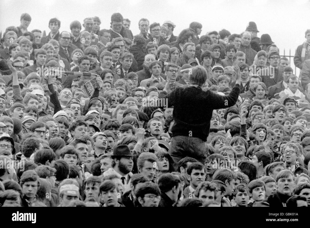 Soccer - FA Cup - Semi Final - West Bromwich Albion v Leicester City. A West Bromwich Albion fan encourages his fellow supporters to sing up in support of their team Stock Photo