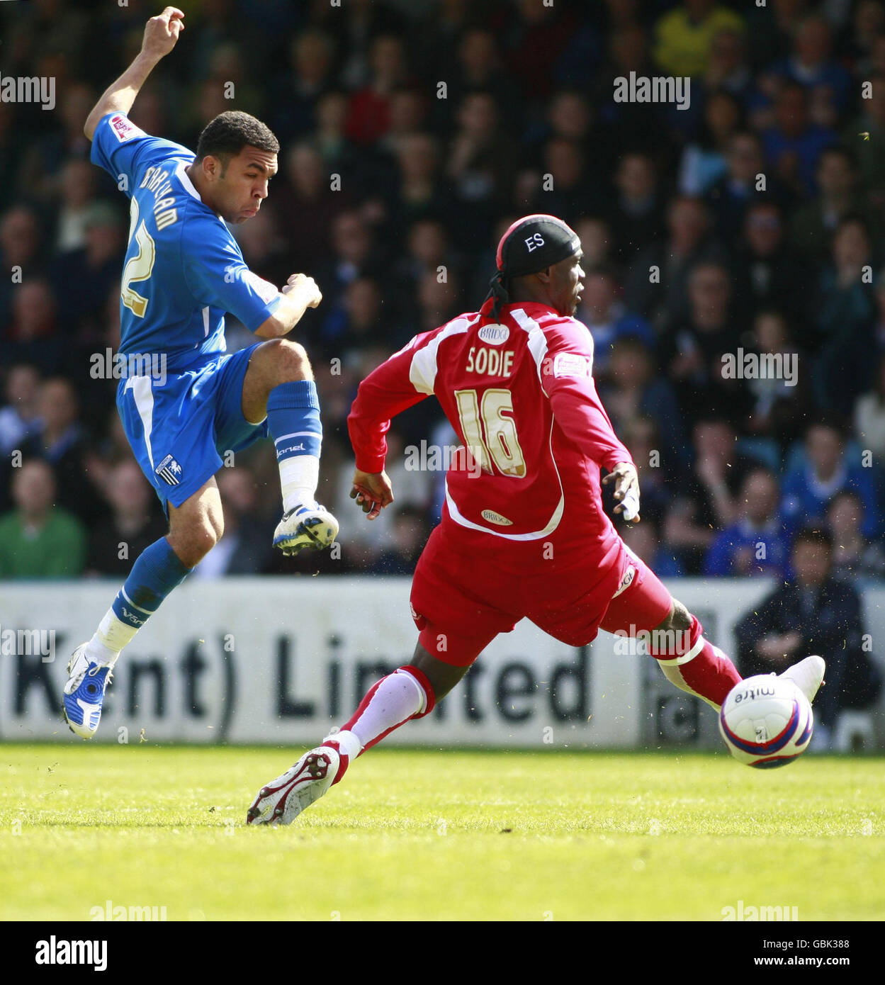Gillingham's Andrew Barcham (right) with Bury's Efetobore Sodje (left) battle for the ball during the Coca-Cola League One match at the KRBS Priestfield Stadium, Gillingham. Stock Photo