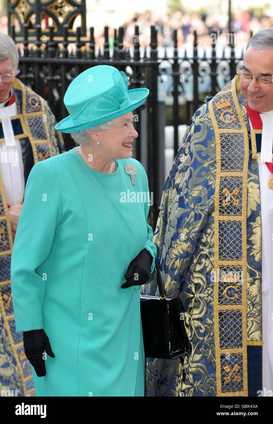 The Queen is escorted by the Dean of Westminster the Very Rev Dr John Hall on her arrival at Westminster Abbey for a service to commemorate the 500th anniversary of the Founder of the Queen's Body Guard of the Yeoman of the Guard. Stock Photo