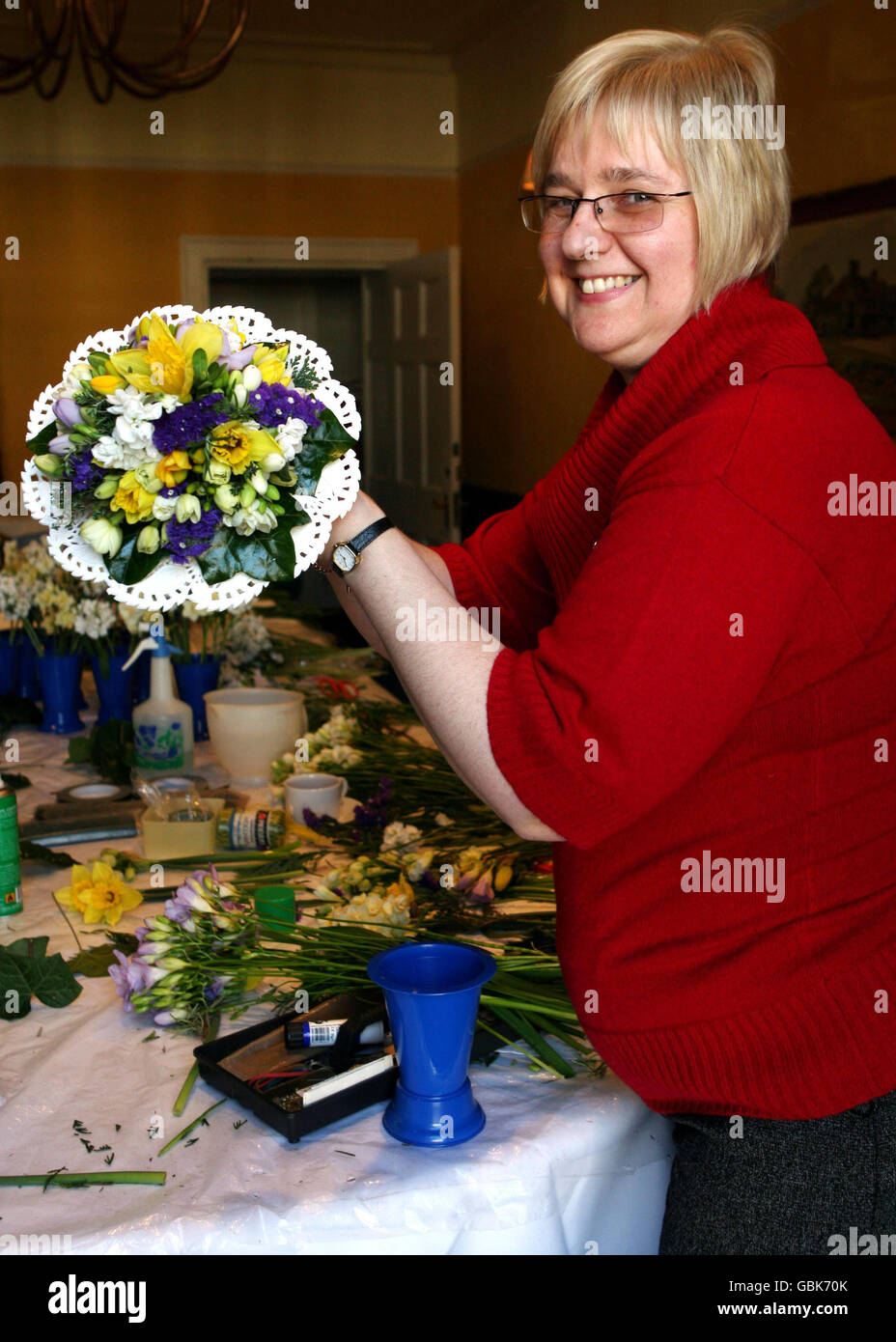 Rosie Mason, 55, the Royal Nosegay maker prepares the Queen's Nosegays at the Angel Hotel in Bury St Edmunds. The posies will be carried by the Royals during the Maundy Thursday Service at Bury St Edmunds Cathedral when Queen Elizabeth II will hand out Maundy coins. Stock Photo