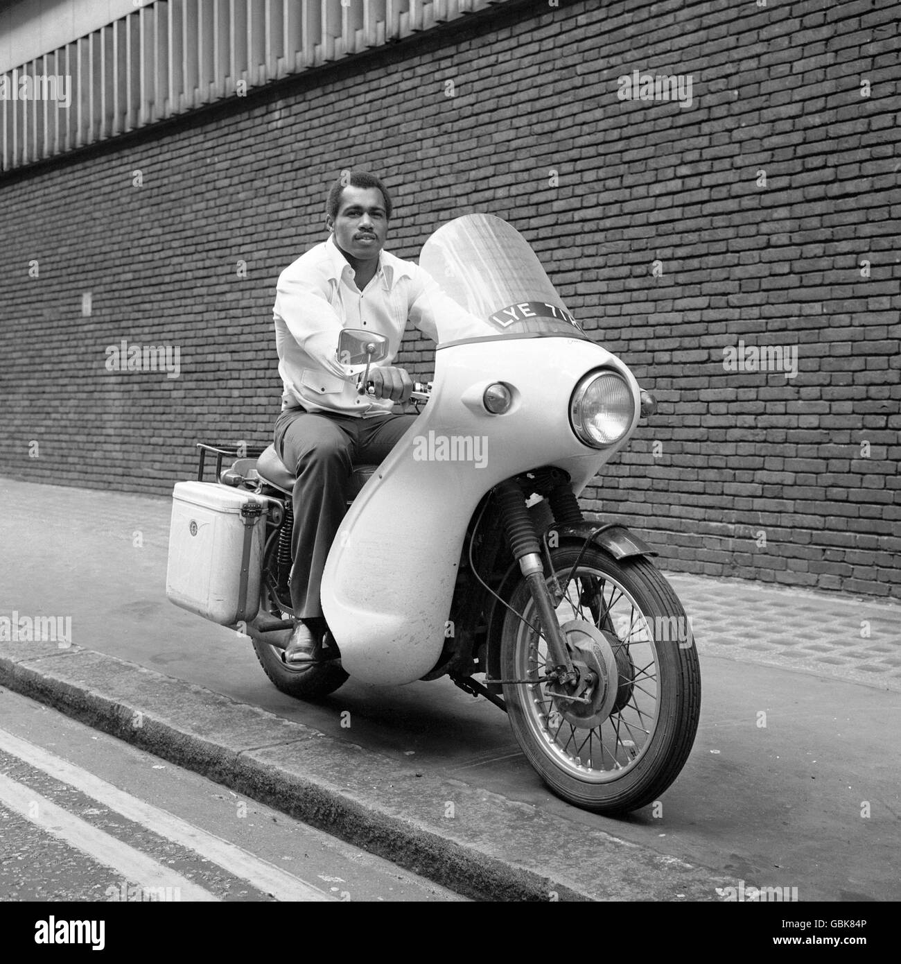 Ken Norton, who defeated Muhammad Ali for the NABF Heavyweight Title, sitting astride another powerful Norton; the 750cc Norton Fastback Commando. Stock Photo