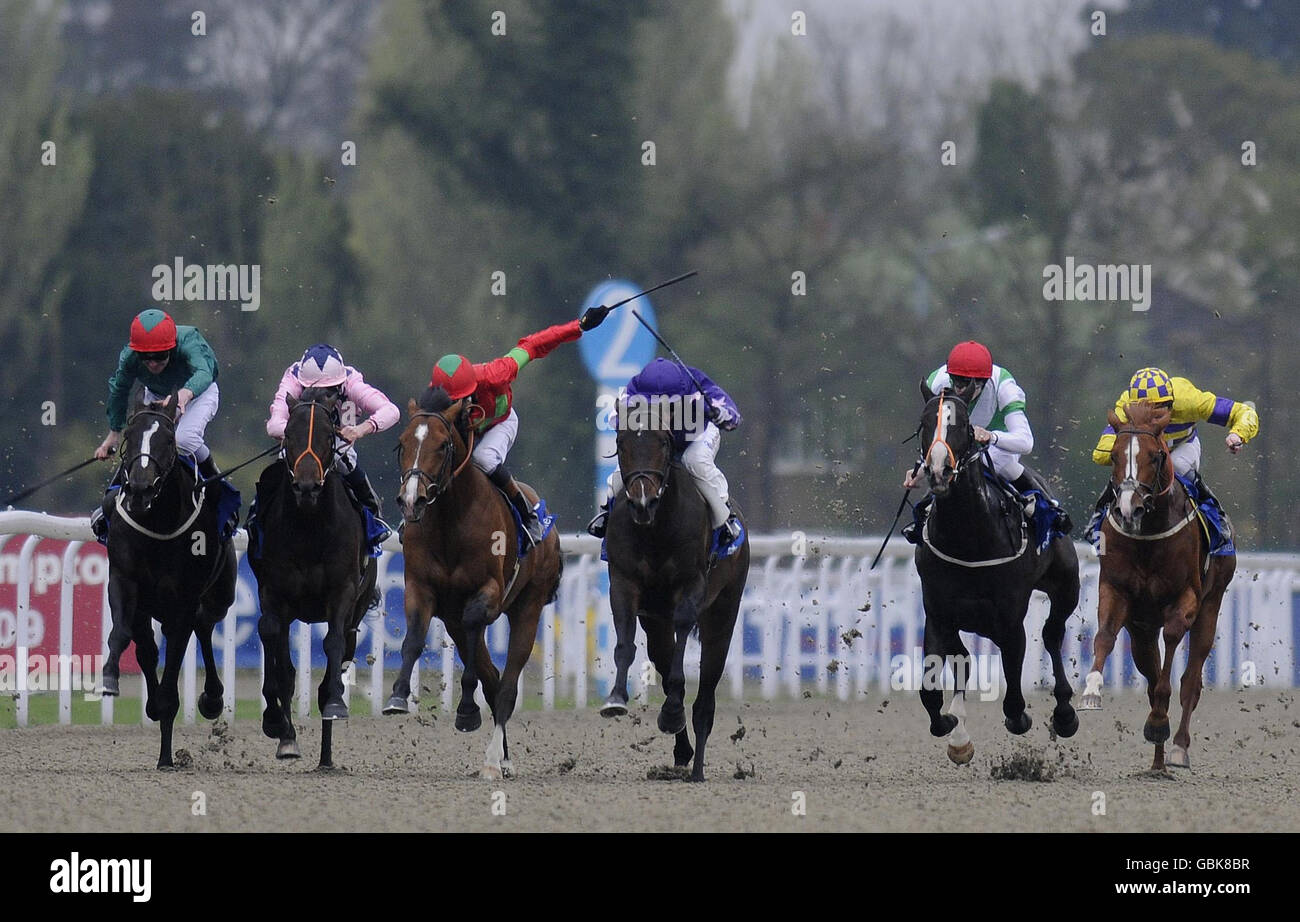 Pure Poetry ridden by Richard Hughes (third left) win The Oddschecker.com Easter Stakes from Shampagne ridden by Martin Dwyer (third right)during the oddschecker.com Easter and Masaka Stakes Day at Kempton Park Racecourse. Stock Photo