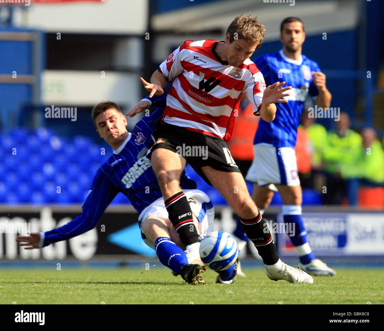 Ipswich Town's Owen Garvan (left) tackles Doncaster Rovers' Martin Woods (right) during the Coca-Cola Football League Championship match at Portman Road, Ipswich. Stock Photo
