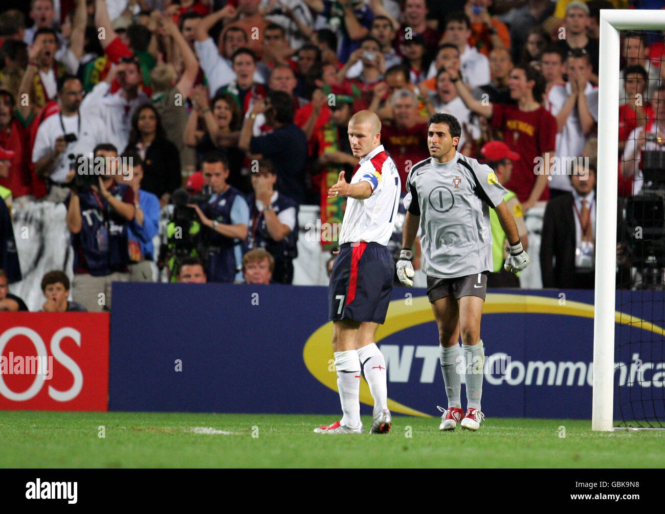 Soccer - UEFA European Championship 2004 - Quarter Final - Portugal v England. England captain David Beckham points to the grass around the penalty spot after blazing the ball over the bar Stock Photo