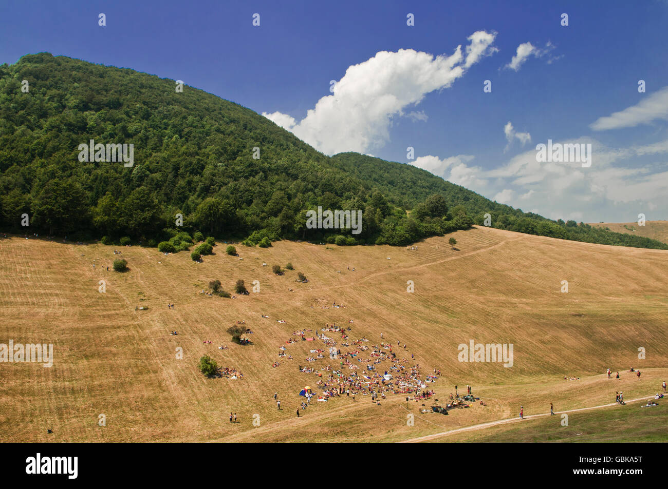 Audience on a mountain during the classical music concert I Suoni delle Dolomiti, Malga Fratte, Plateau Vezzena, Levico, Trento Stock Photo