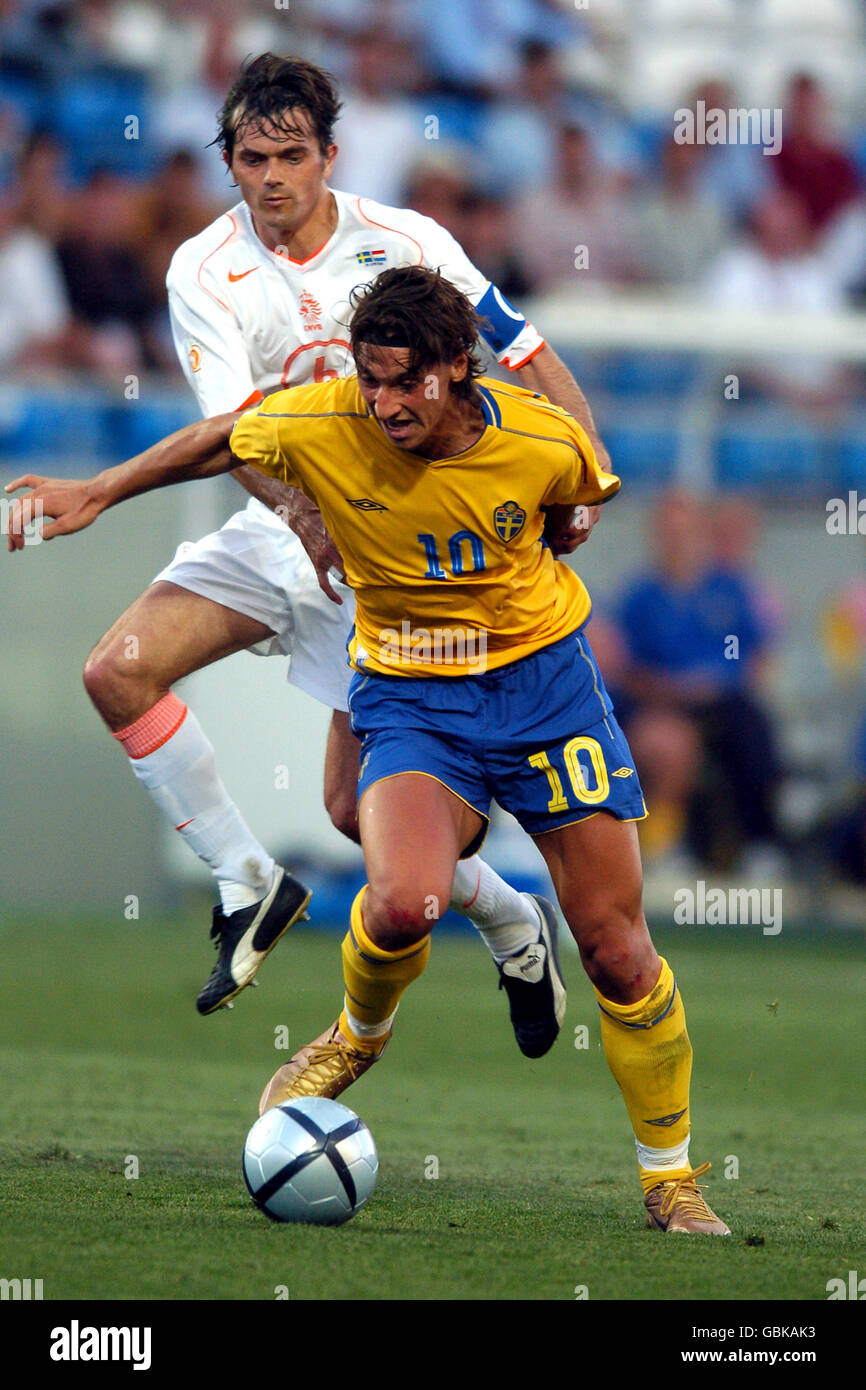 Holland's Phillip Cocu (back) pulls back Sweden's Zlatan Ibrahimovic (front  Stock Photo - Alamy