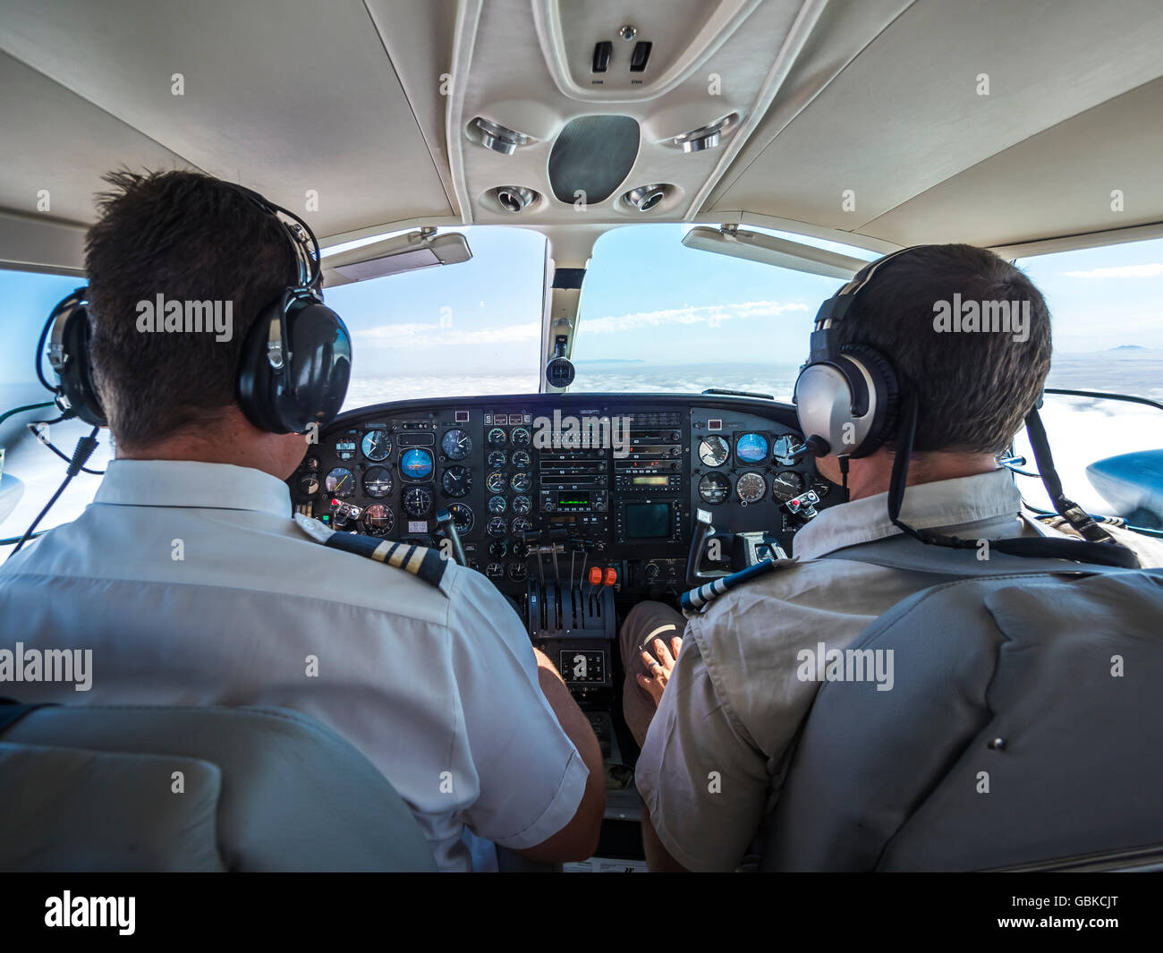 Two pilots in a cockpit, controlling a small aircraft Cessna 406, Namibia Stock Photo