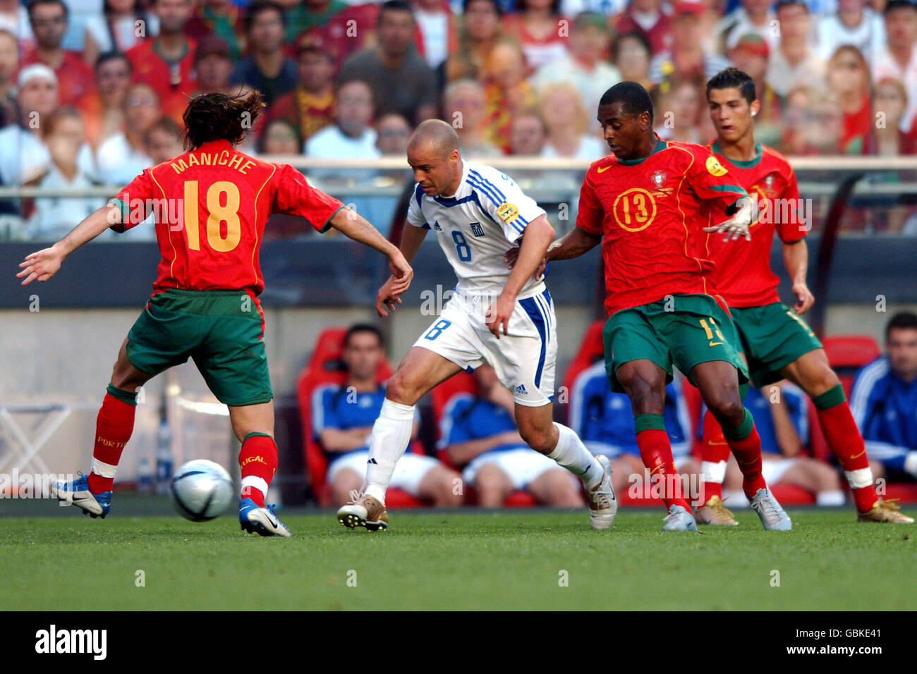 Soccer - UEFA European Championship 2004 - Final - Portugal v Greece. Greece's Stylianos Giannakopoulos takes on Portugal's Maniche (l) Miguel (second right) and Cristiano Ronaldo (r) Stock Photo