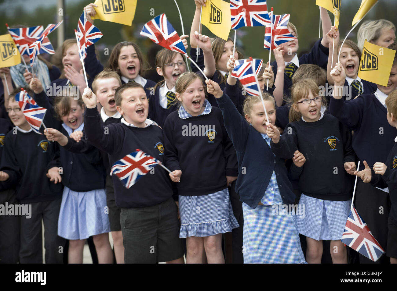 Children wait for Prince William's visit to the World Headquarters of JCB, one of the world's largest manufacturers of construction equipment, to mark the production of the company's 750,000th machine at JC Bamford Excavators Ltd, Rocester, Staffordshire. Stock Photo