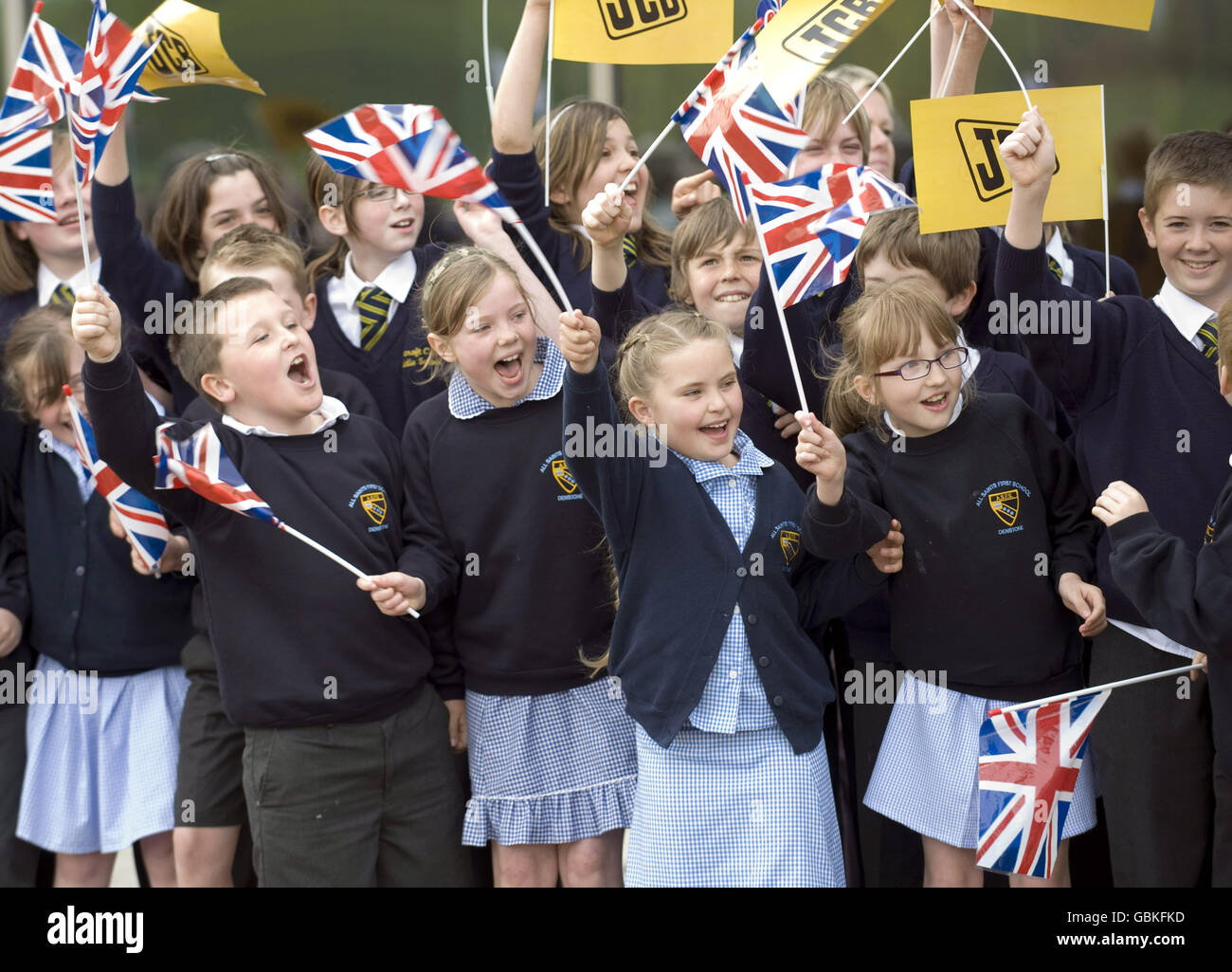 Children wait for Prince William to visit the World Headquarters of JCB, one of the world's largest manufacturers of construction equipment, to mark the production of the company's 750,000th machine at JC Bamford Excavators Ltd, Rocester, Staffordshire. Stock Photo