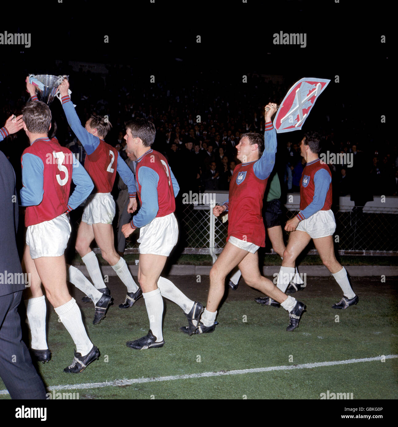 Soccer - European Cup Winners Cup - Final - West Ham United v TSV 1860  Munich. West Ham United's Brian Dear (second l) parades a giant version of  the club's badge around