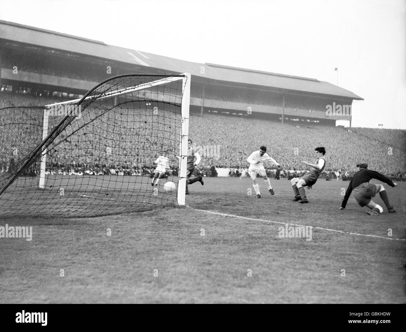 Real Madrid's Ferenc Puskas (third r) slots home his team's fifth goal, completing his hat-trick, as Eintracht Frankfurt goalkeeper Egon Loy (r) looks on helplessly Stock Photo