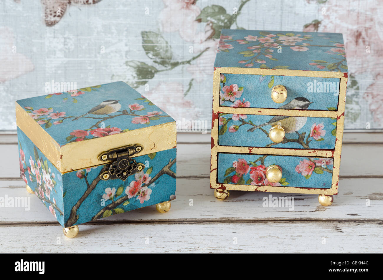 Hnadmade trinket box and mini chest of drawers on a shabby chic background Stock Photo