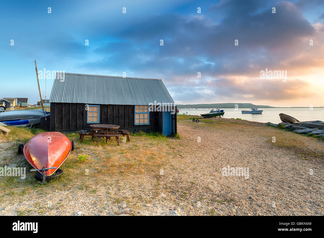 Boat sheds and beach huts at Mudeford Spit in Christchurch harbour on the Dorset coast Stock Photo