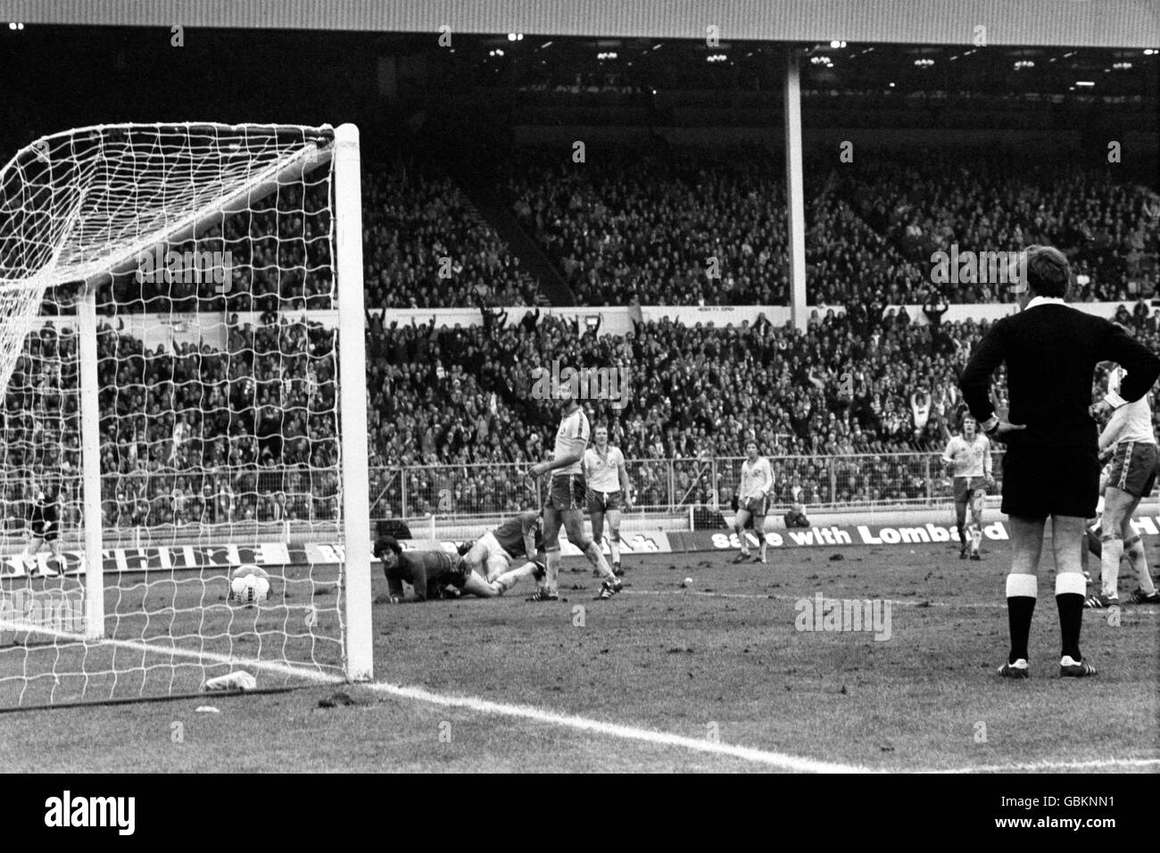 Nottingham Forest's Tony Woodcock (second l) slides the ball past Southampton's Terry Gennoe (l) and Chris Nicholl (third l) to score his team's third goal Stock Photo