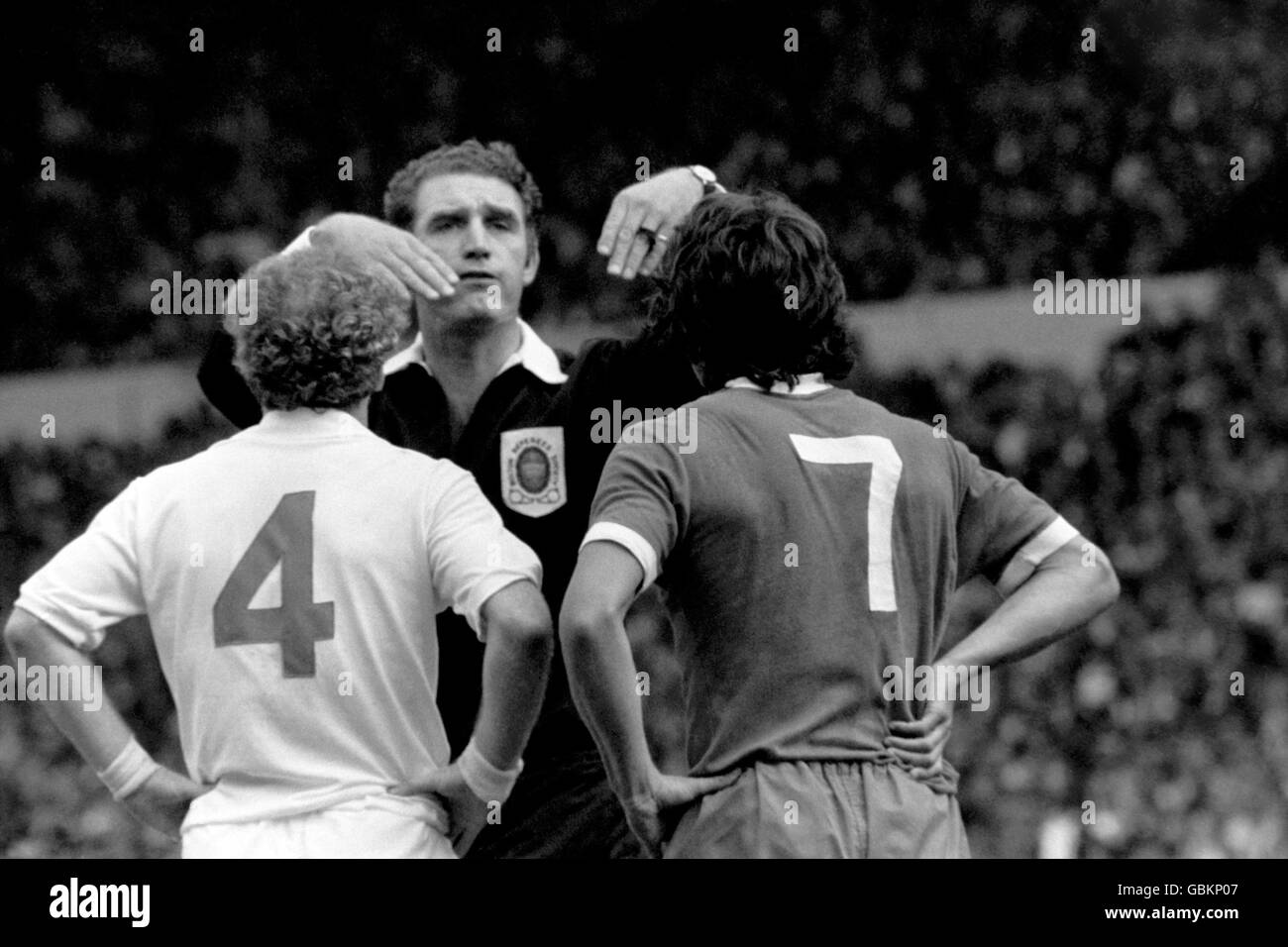 Referee Reg Matthewson (c) sends off Leeds United's Billy Bremner (l) and Liverpool's Kevin Keegan (r) after they traded punches during the match Stock Photo
