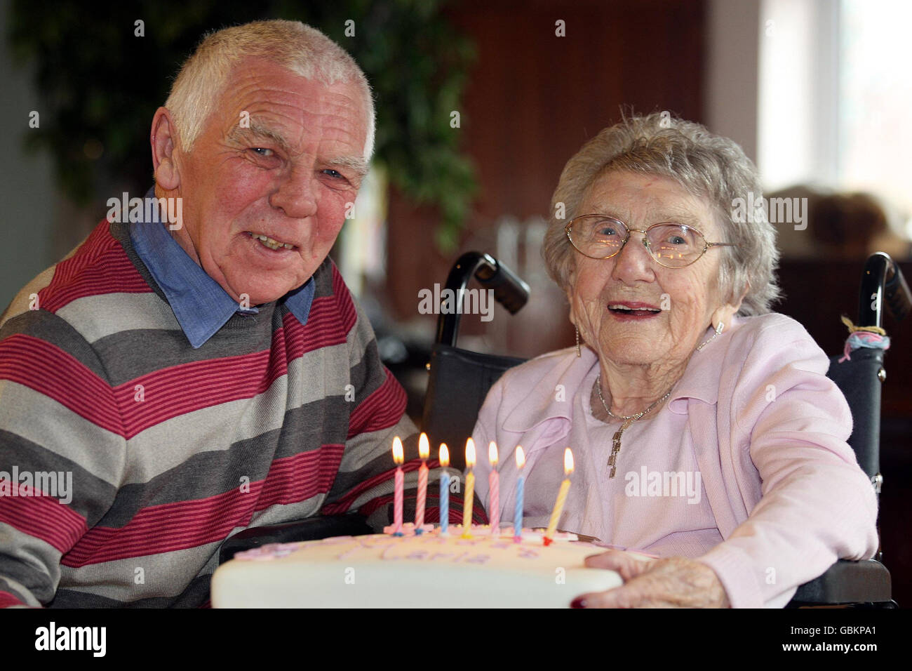 William McQuillan with his mother Maria McQuillan, who is 107-years-old today, as she celebrates her birthday at the City Way Day Centre in south Belfast. Stock Photo