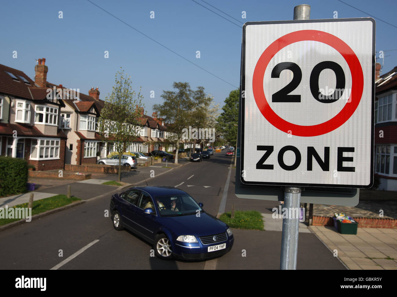 A car passes a 20mph speed limit sign in morden hires stock