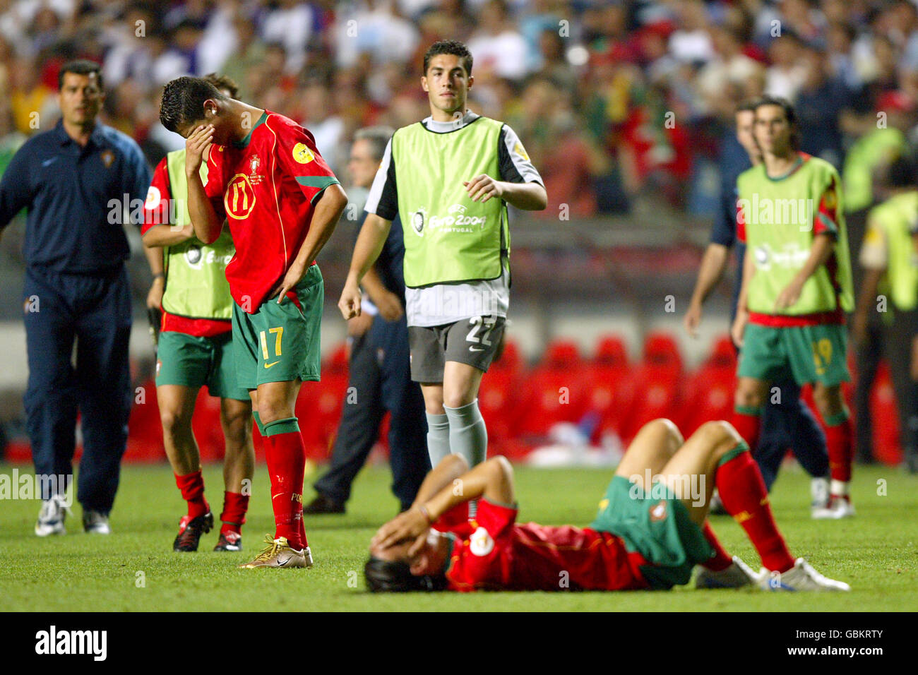 Soccer - UEFA European Championship 2004 - Final - Portugal v Greece. Portugal's Nuno Gomes lies dejected as Cristiano Ronaldo stands in tears Stock Photo