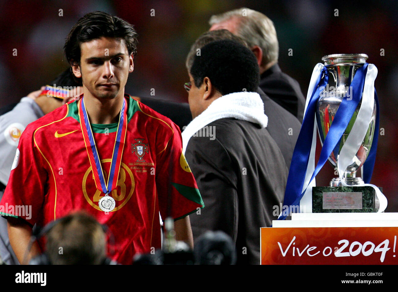 A dejected Helder Postiga of Portugal walks past Eusebio and the trophy Stock Photo