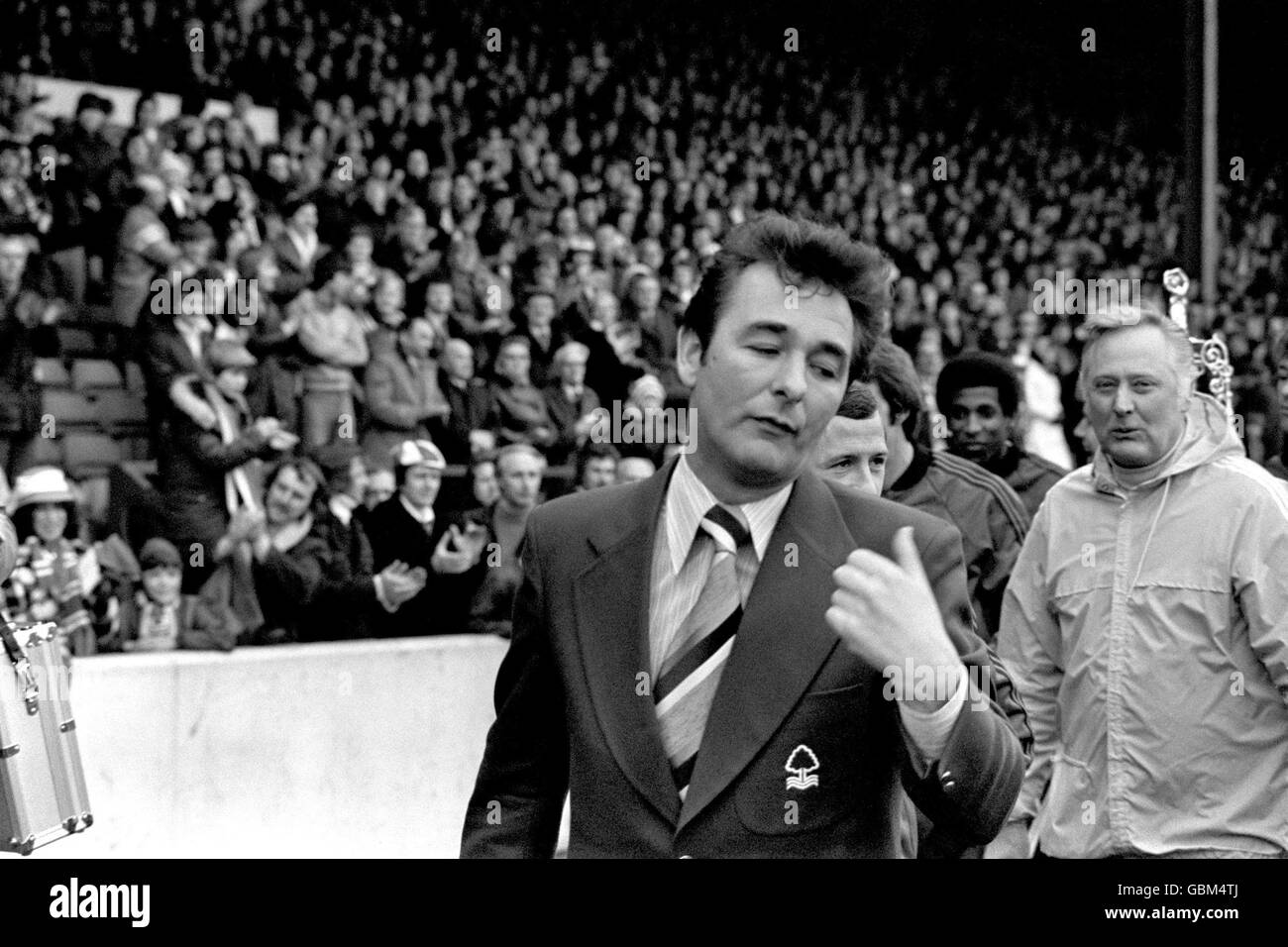 Nottingham Forest manager Brian Clough points at his assistant Peter Taylor (r) as they and their players parade the League Championship and League Cup around the City Ground after the match Stock Photo