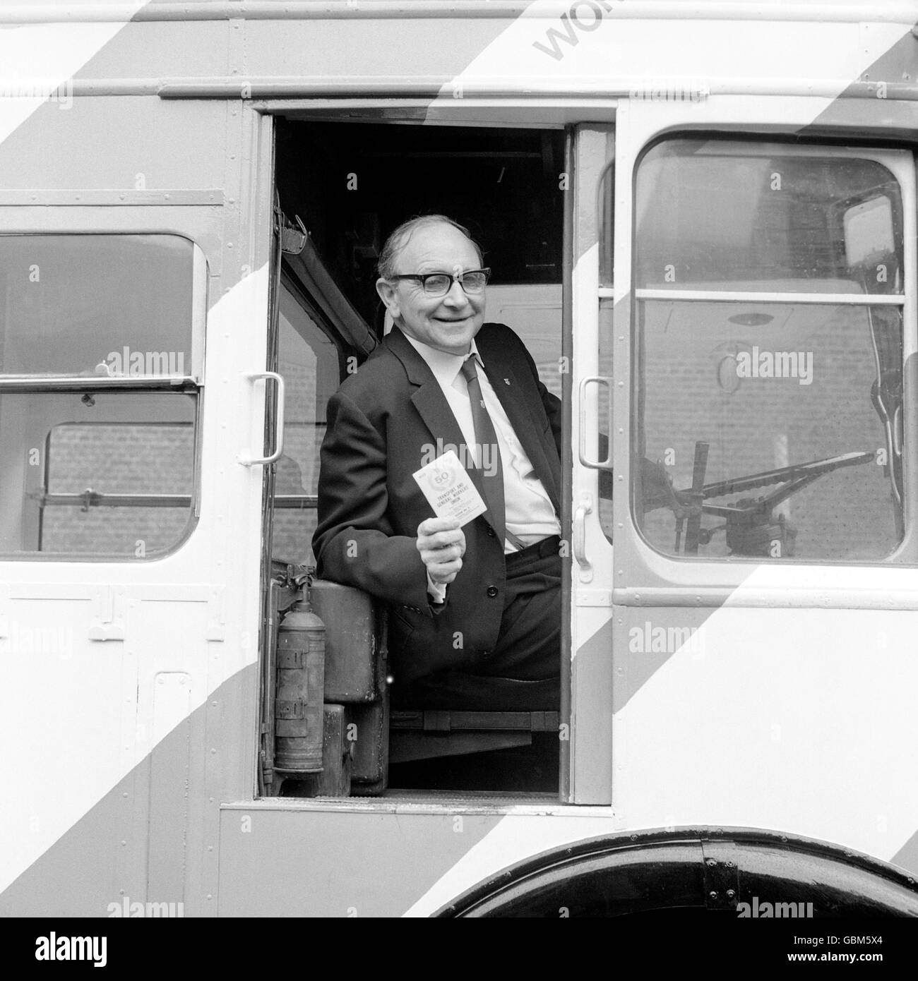 Brandishing his membership card, Mr Jack Jones, General Secretary,  Transport and General Worker's Union, at wheel of the Union Bus at Victoria  LTB bus garage Stock Photo - Alamy