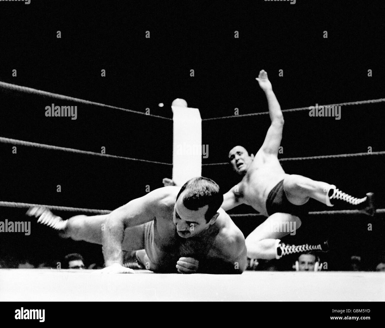 England's Mick McManus (r) is thrown clear across the ring by France's Gilbert Cesca (l) Stock Photo