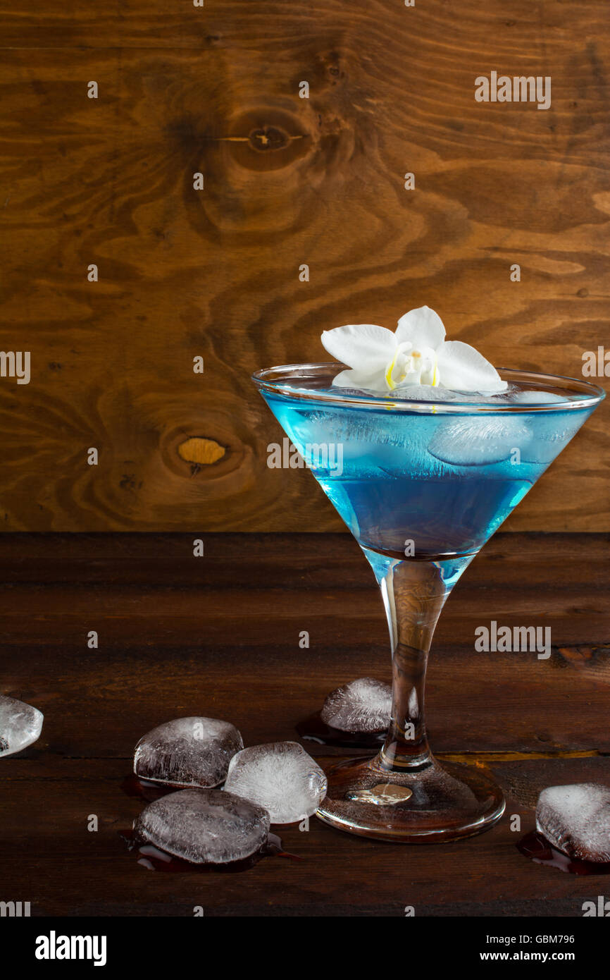 Blue cosmopolitan cocktail on wooden background. Blue margarita. Blue ...