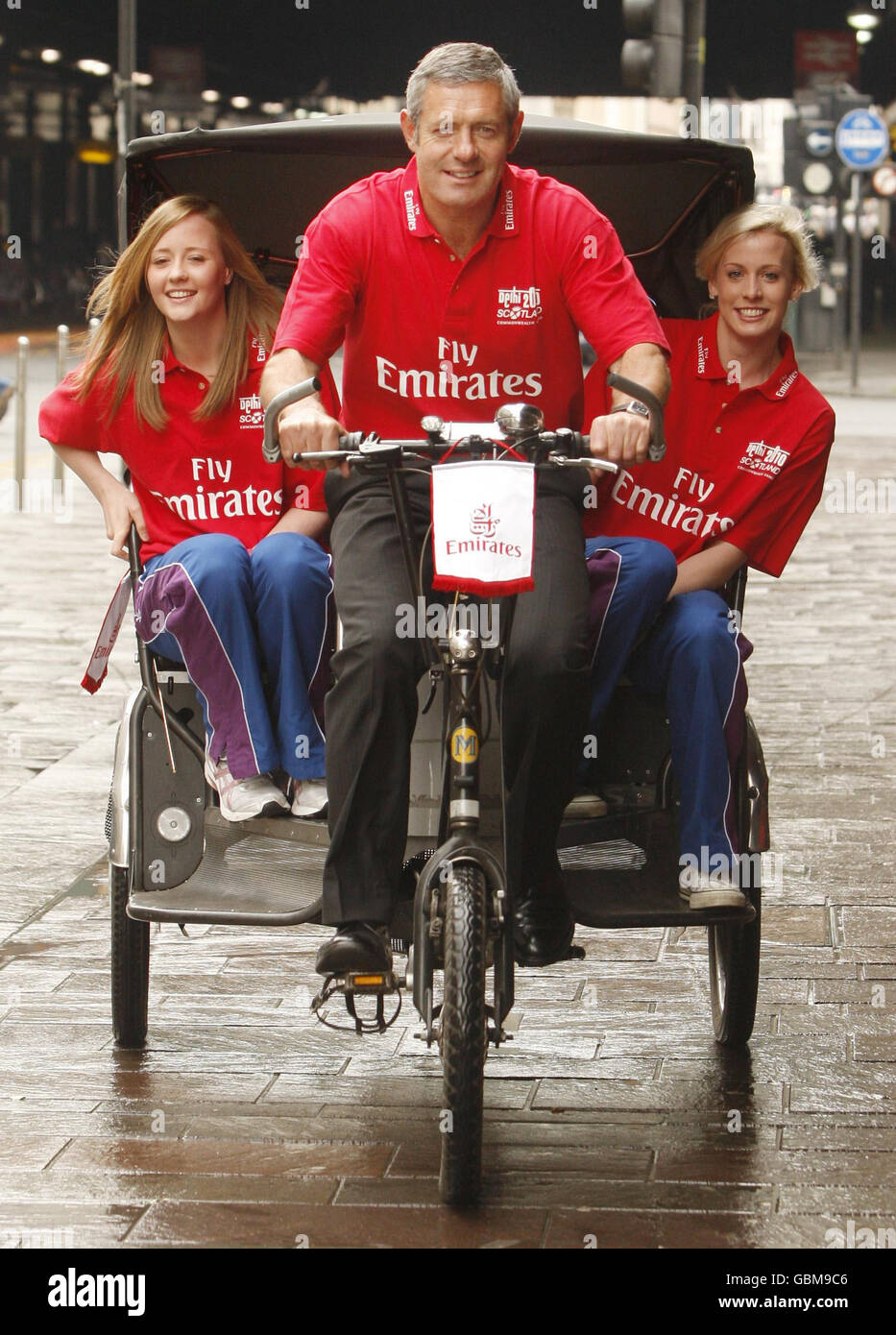 Rugby star and Commonwealth Ambassador Gavin Hastings with Commonwealth Youth Games medal winners Robyn Mathews (left) and Lynsey Sharp (right), on a tuck tuck (rickshaw) on Argyle Street in Glasgow, to promote the announcement of Emirates Airline as a sponsor for the Scottish Commonwealth Games team. Stock Photo
