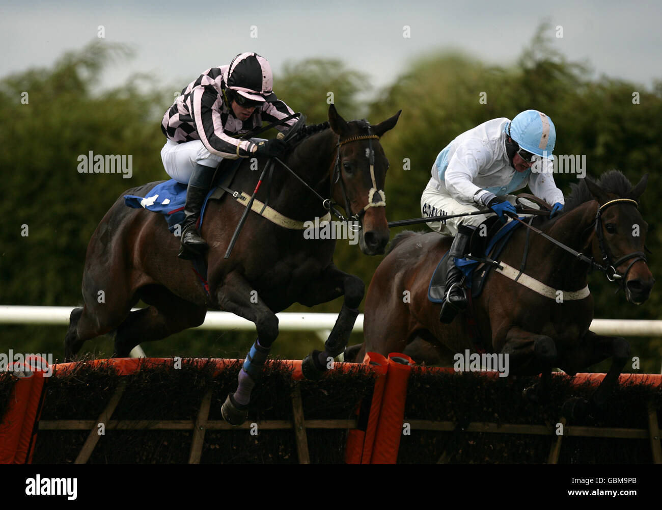 Sylroy ridden by jockey Peter Toole (L) jumps the last fence to win the Wye Valley Brewery Mares' Novices' Hurdle Race at Hereford Racecouse Stock Photo
