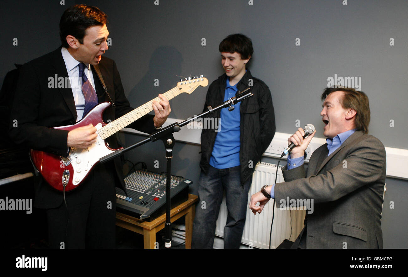 Culture Secretary Andy Burnham (left) and UK Music Chief Executive Feargal Sharkey play Teenage Kicks during the opening of a professionally equipped, Government funded music rehearsal space in Knotty Ash, Liverpool. Stock Photo